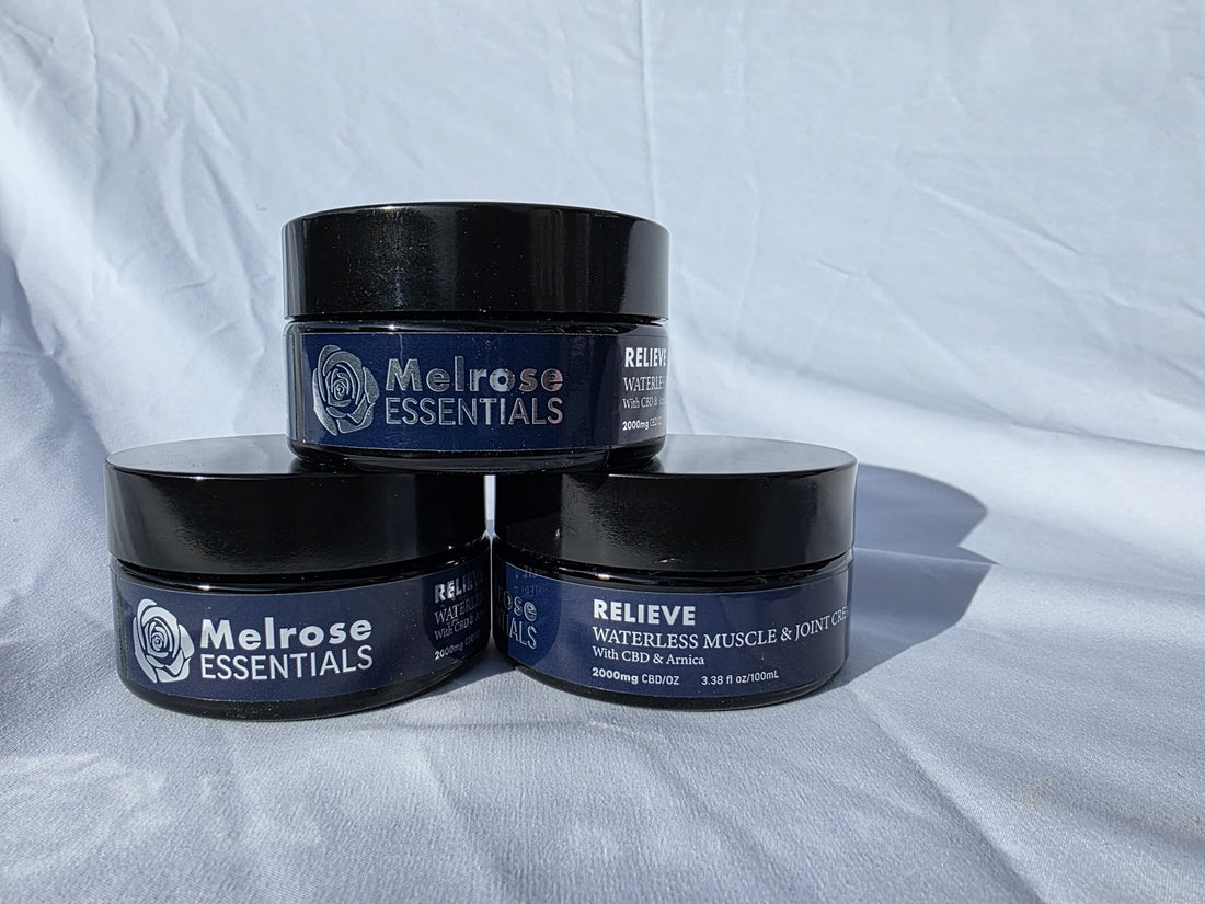 Three jars of Melrose Relieve waterless CBD balm stacked on a white backdrop