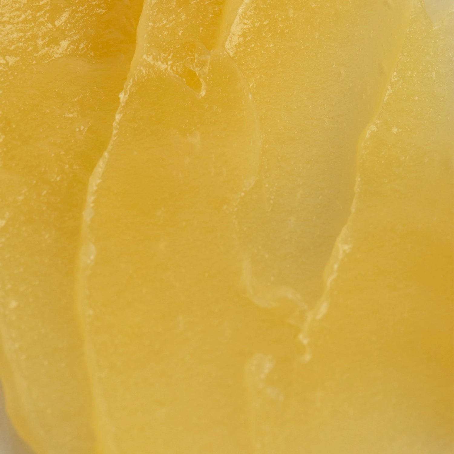 Close up of the bright yellow texture of Melrose Essentials Relieve CBD cream.
