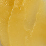 Close up of the bright yellow texture of Melrose Essentials Relieve CBD cream.