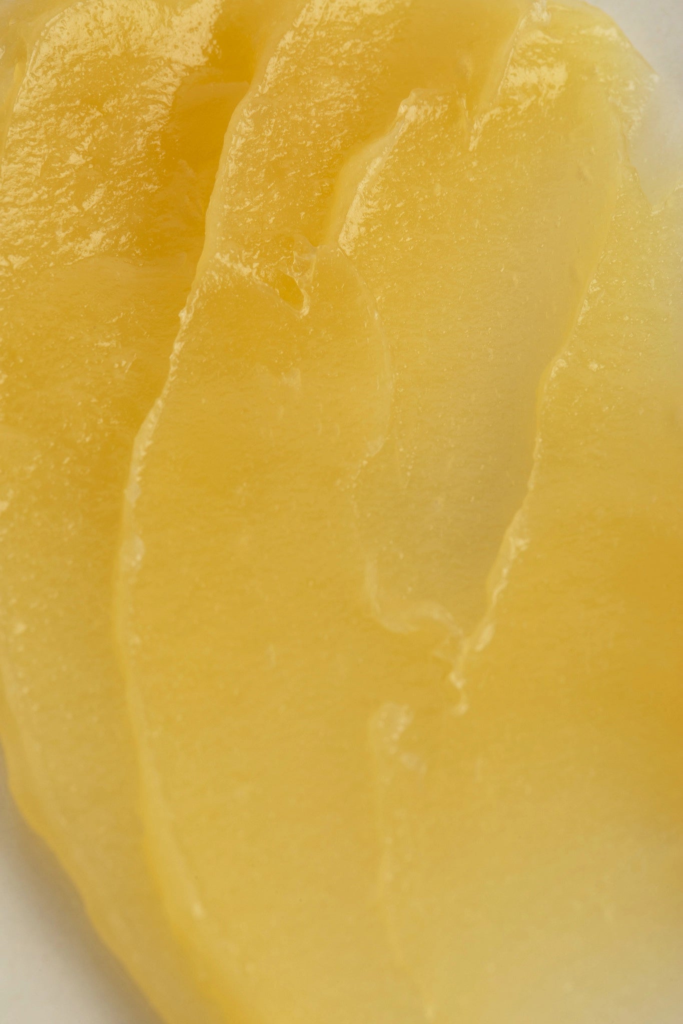 Close up of the bright yellow texture of Melrose Essentials Relieve CBD cream.