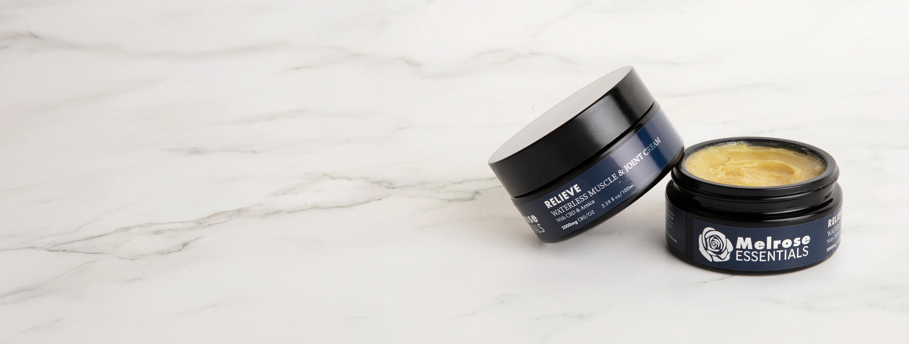 Two jars of Melrose Essentials Relieve CBD cream on a white surface