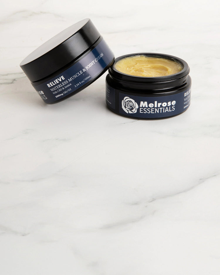 Two jars of Melrose Essentials Relieve CBD cream on a white surface